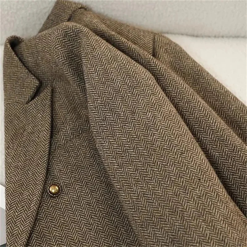 Women's slim fit blazer in brown herringbone tweed - closeup detail of fabric texture and gold button