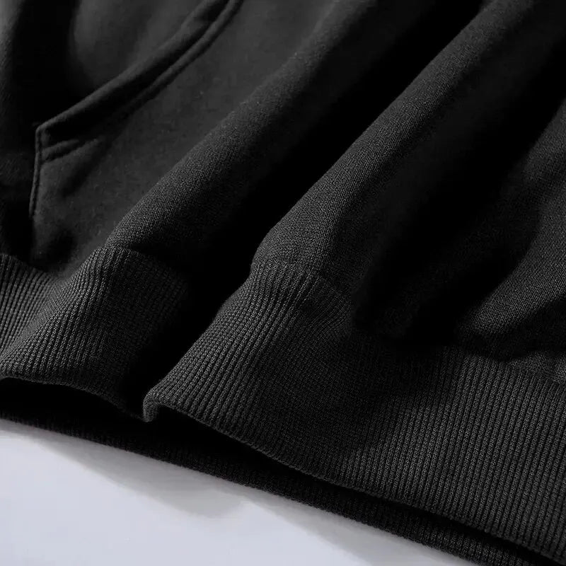 Close-up of black hoodie tracksuit fleece fabric with ribbed cuffs detail