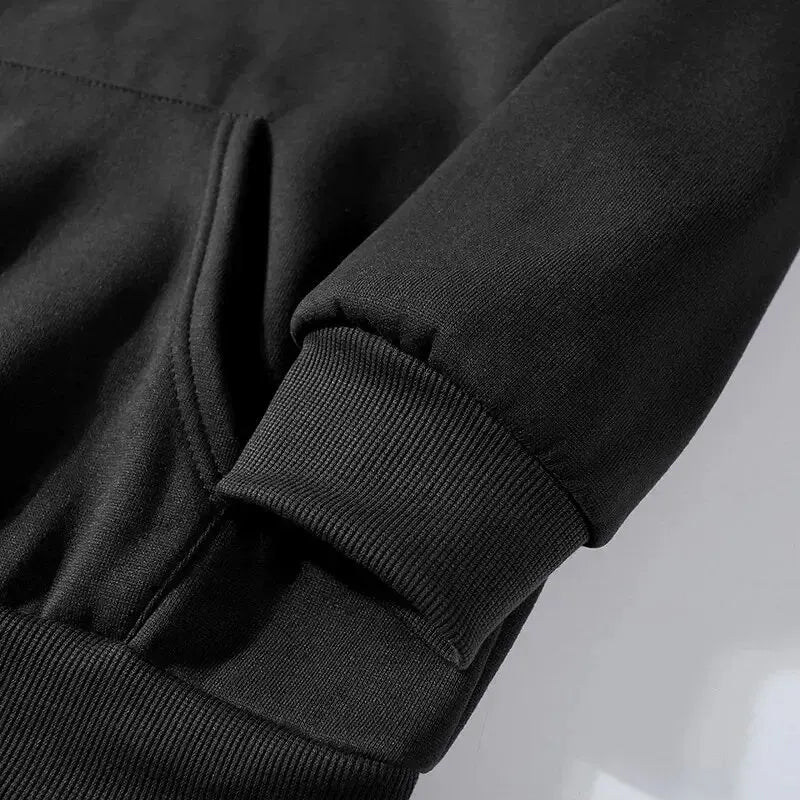 Close-up of black tracksuit pants fleece fabric with ribbed cuffs detail