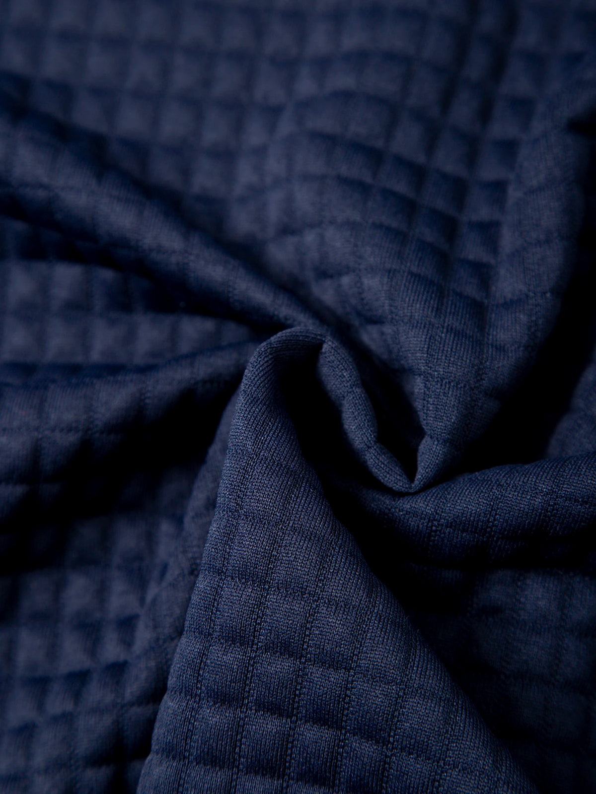 Men's waffle knit pullover hoodie in navy, close-up of fabric texture