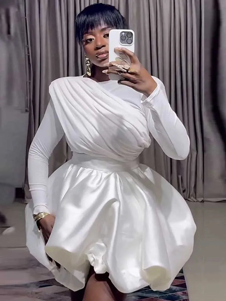 Woman wearing white puff sleeve bubble hem mini dress, mirror selfie pose
