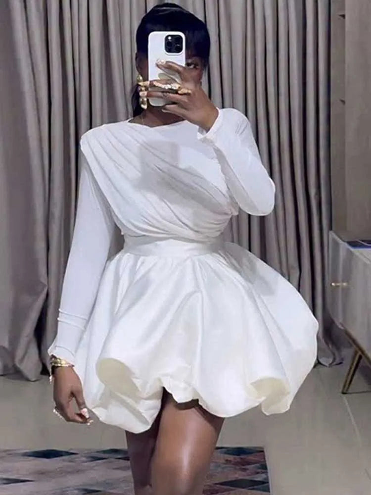 Woman wearing white puff sleeve bubble hem mini dress, front pose