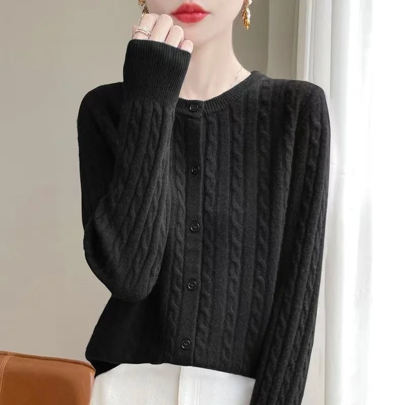 Women's black cable knit crew neck sweater on model